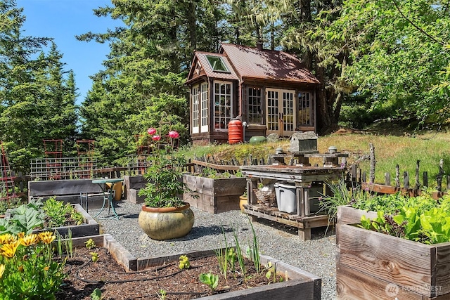 354 Nighthawk Ln, Orcas Island, WA 98279 - view of patio / terrace featuring a garden, an outdoor structure, and french doors