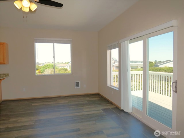 1080 Greenview Ct SW, Ocean Shores, WA 98569 - empty room featuring a ceiling fan, dark wood-style flooring, and baseboards