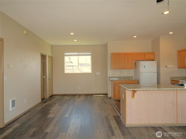 1080 Greenview Ct SW, Ocean Shores, WA 98569 - kitchen featuring freestanding refrigerator, light stone counters, dark wood-type flooring, recessed lighting, and light brown cabinetry