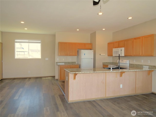 1080 Greenview Ct SW, Ocean Shores, WA 98569 - kitchen with white appliances, a peninsula, dark wood finished floors, light stone countertops, and recessed lighting