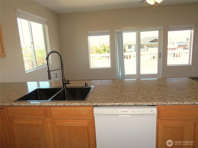 1080 Greenview Ct SW, Ocean Shores, WA 98569 - kitchen with white dishwasher, a sink, ceiling fan, and light stone countertops