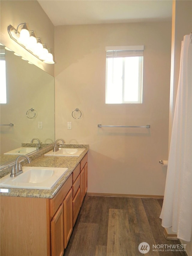 1080 Greenview Ct SW, Ocean Shores, WA 98569 - bathroom with wood finished floors, double vanity, and baseboards