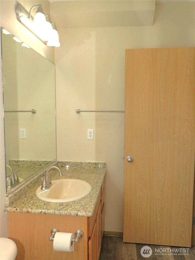 1080 Greenview Ct SW, Ocean Shores, WA 98569 - bathroom with vanity, wood finished floors, and toilet