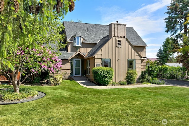 1701 W Yakima Ave, Yakima, WA 98902 - english style home with a shingled roof, board and batten siding, a front yard, and a chimney