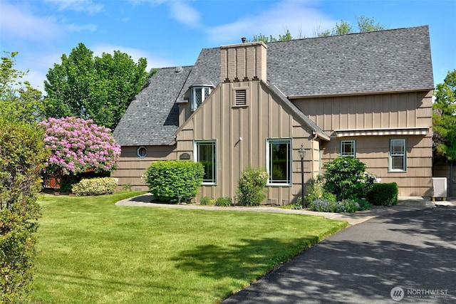 1701 W Yakima Ave, Yakima, WA 98902 - view of front facade featuring roof with shingles, a front yard, and board and batten siding
