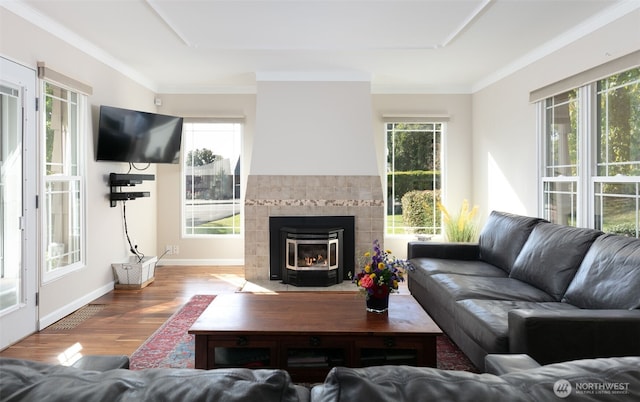 1701 W Yakima Ave, Yakima, WA 98902 - living room featuring wood finished floors, baseboards, crown molding, and a tiled fireplace