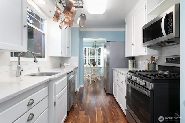 1701 W Yakima Ave, Yakima, WA 98902 - kitchen featuring appliances with stainless steel finishes, crown molding, white cabinets, a sink, and decorative backsplash