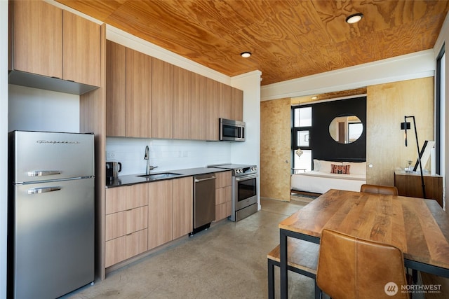 23692 Cliffe Pointe Rd NW Unit 6B, Quincy, WA 98848 - kitchen featuring appliances with stainless steel finishes, a sink, modern cabinets, finished concrete flooring, and dark countertops