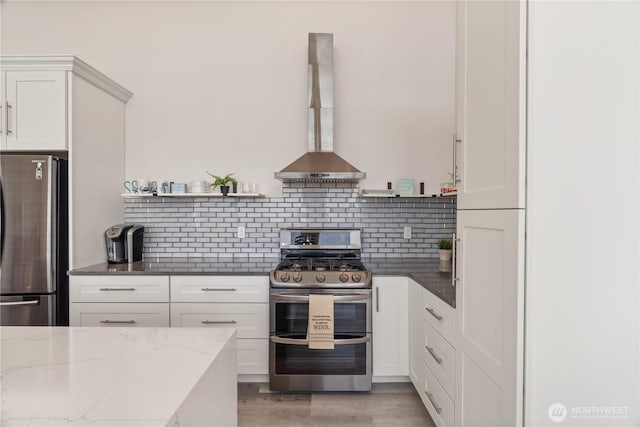 1438 Ocean Crest Ave SW, Ocean Shores, WA 98569 - kitchen with stainless steel appliances, wall chimney exhaust hood, tasteful backsplash, dark stone counters, and open shelves