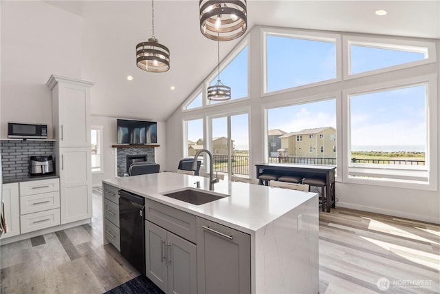 1438 Ocean Crest Ave SW, Ocean Shores, WA 98569 - kitchen with a sink, stainless steel microwave, open floor plan, black dishwasher, and light wood-type flooring