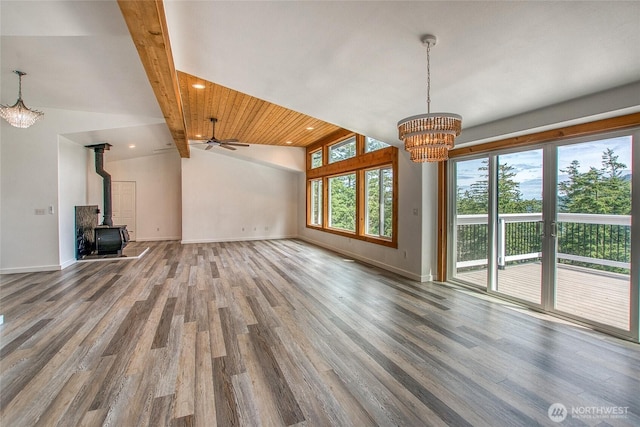 16 Village View Rd, Orcas Island, WA 98245 - unfurnished living room with a chandelier, wood finished floors, a wood stove, baseboards, and recessed lighting