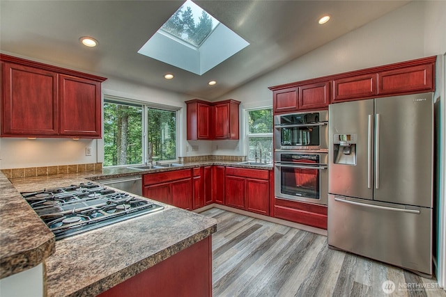 16 Village View Rd, Orcas Island, WA 98245 - kitchen with appliances with stainless steel finishes, dark brown cabinets, a sink, lofted ceiling, and plenty of natural light
