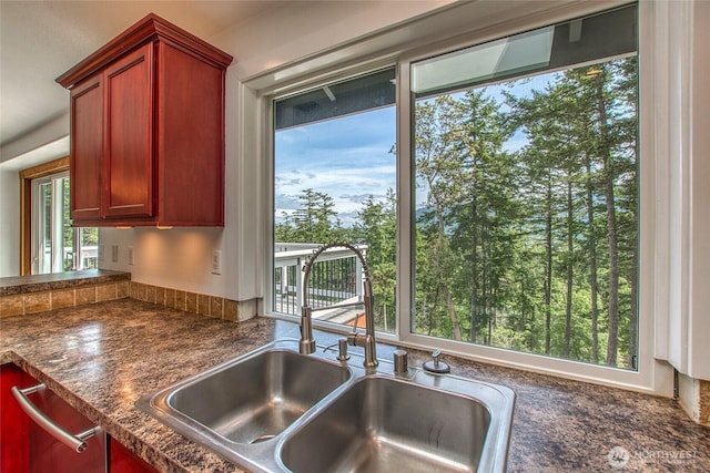 16 Village View Rd, Orcas Island, WA 98245 - kitchen featuring a sink, dark countertops, and reddish brown cabinets