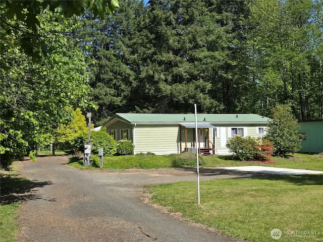 14721 Morris Rd Unit 21, Randle, WA 98377 - view of front of property featuring dirt driveway, a front yard, and metal roof