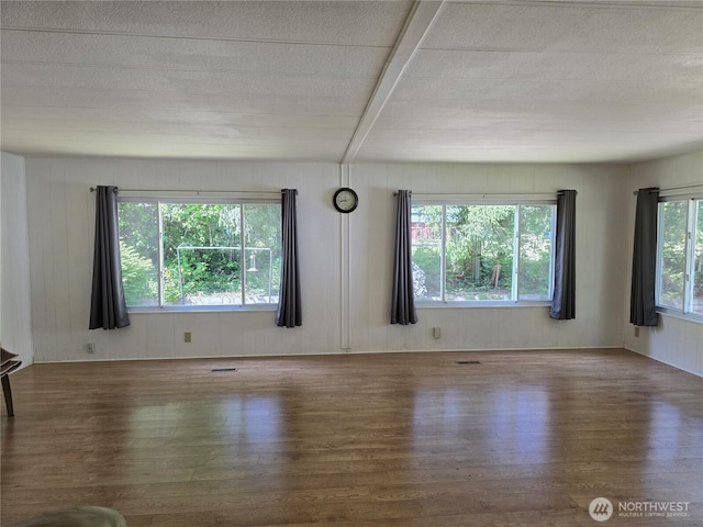 14721 Morris Rd Unit 21, Randle, WA 98377 - unfurnished living room featuring wood finished floors and beam ceiling