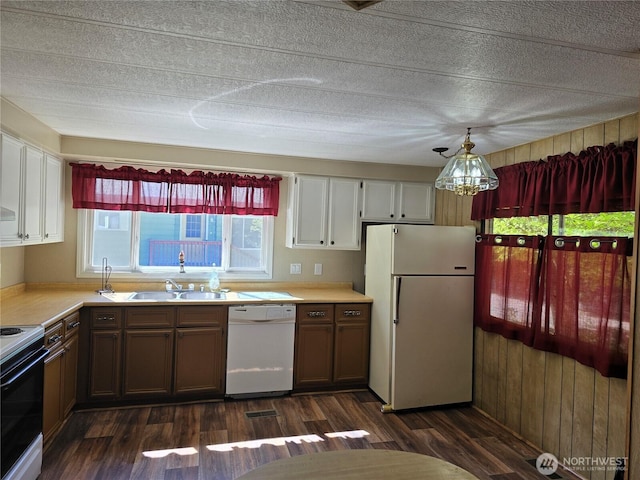 14721 Morris Rd Unit 21, Randle, WA 98377 - kitchen featuring white appliances, a sink, light countertops, dark wood-type flooring, and a textured ceiling