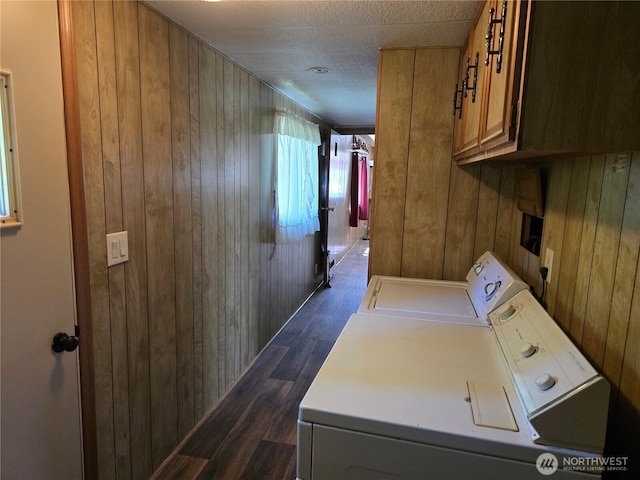 14721 Morris Rd Unit 21, Randle, WA 98377 - laundry room featuring washing machine and clothes dryer, cabinet space, wood walls, and dark wood finished floors