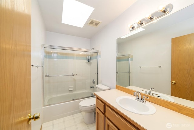 14415 144th St E, Orting, WA 98360 - full bath with vanity, toilet, combined bath / shower with glass door, tile patterned floors, and a skylight