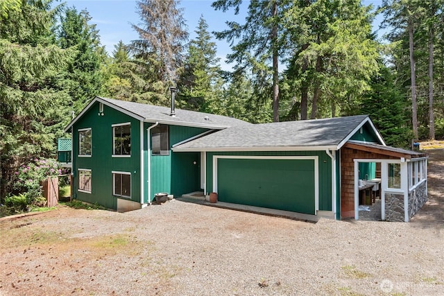 60 E Christmas Tree Pl, Belfair, WA 98528 - view of front of house with a garage, driveway, and a shingled roof