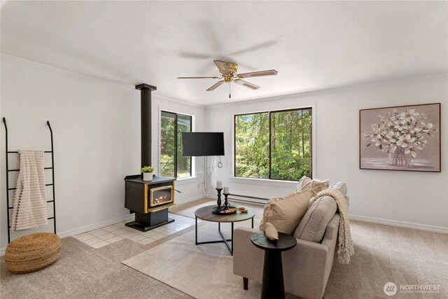 60 E Christmas Tree Pl, Belfair, WA 98528 - living area with a wood stove, a ceiling fan, light colored carpet, baseboards, and ornamental molding