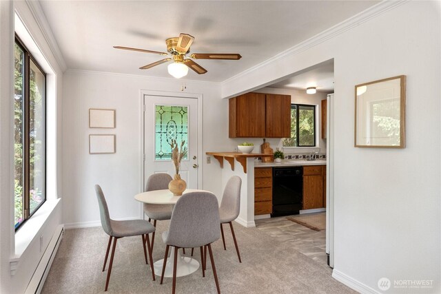 60 E Christmas Tree Pl, Belfair, WA 98528 - dining space featuring baseboard heating, healthy amount of natural light, light carpet, ornamental molding, and ceiling fan