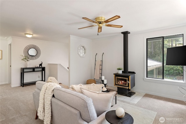 60 E Christmas Tree Pl, Belfair, WA 98528 - living room featuring a wood stove, light colored carpet, ornamental molding, ceiling fan, and baseboards
