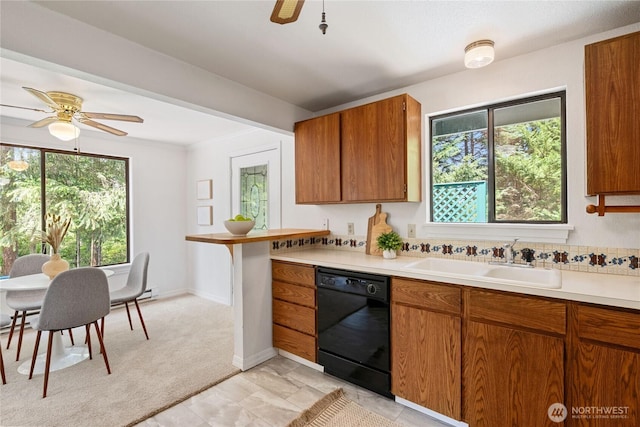 60 E Christmas Tree Pl, Belfair, WA 98528 - kitchen with black dishwasher, ceiling fan, a sink, brown cabinetry, and light countertops