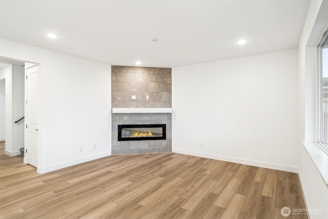 20304 150th St E, Bonney Lake, WA 98391 - unfurnished living room featuring a fireplace, light wood finished floors, baseboards, and recessed lighting