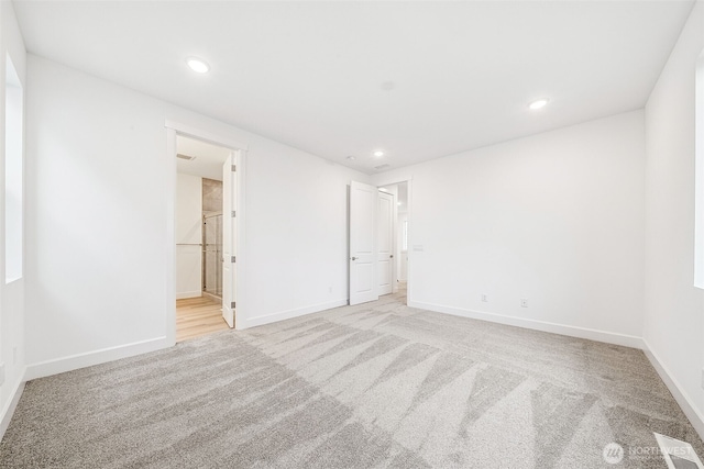 20304 150th St E, Bonney Lake, WA 98391 - unfurnished bedroom featuring light carpet, baseboards, recessed lighting, and ensuite bathroom