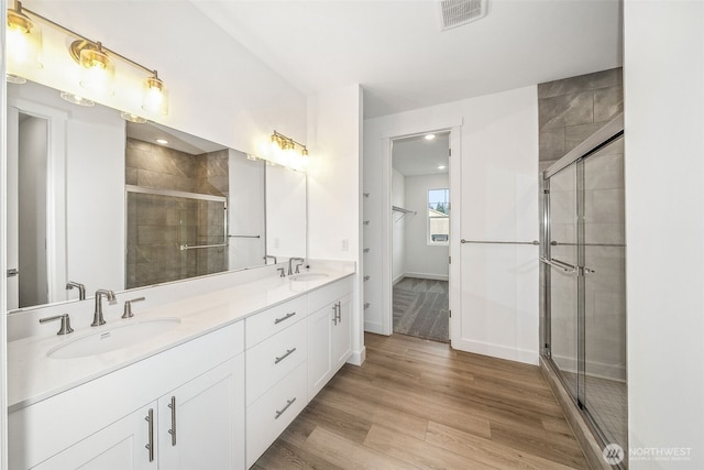 20304 150th St E, Bonney Lake, WA 98391 - full bath with double vanity, a stall shower, wood finished floors, and baseboards