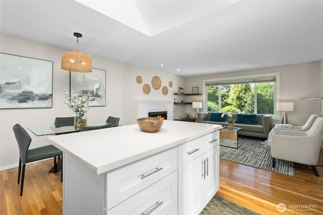 9035 NE 137th, Kirkland, WA 98034 - kitchen with open floor plan, light wood-type flooring, a fireplace, light countertops, and recessed lighting