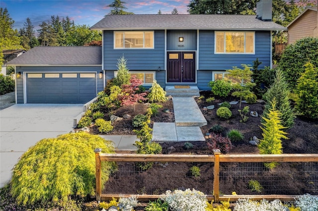 9035 NE 137th, Kirkland, WA 98034 - bi-level home featuring a garage, driveway, a chimney, and a shingled roof