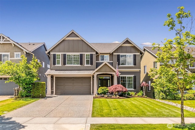 912 77th Dr SE, Lake Stevens, WA 98258 - craftsman-style house with board and batten siding, concrete driveway, an attached garage, a front yard, and a shingled roof