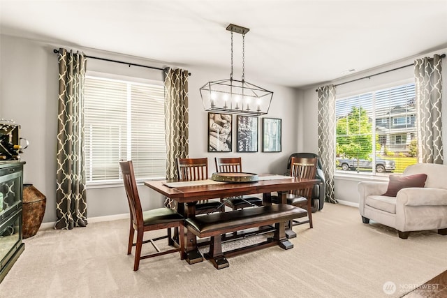 912 77th Dr SE, Lake Stevens, WA 98258 - dining space with a chandelier, baseboards, and light carpet