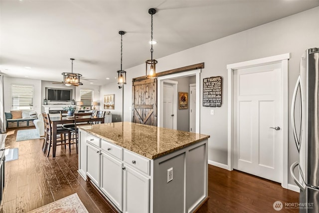 912 77th Dr SE, Lake Stevens, WA 98258 - kitchen featuring freestanding refrigerator, dark wood-style flooring, a kitchen island, white cabinets, and recessed lighting