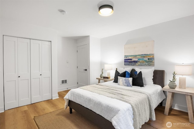 11550 22nd Ave NE, Seattle, WA 98125 - bedroom featuring light wood-style flooring, a closet, and baseboards