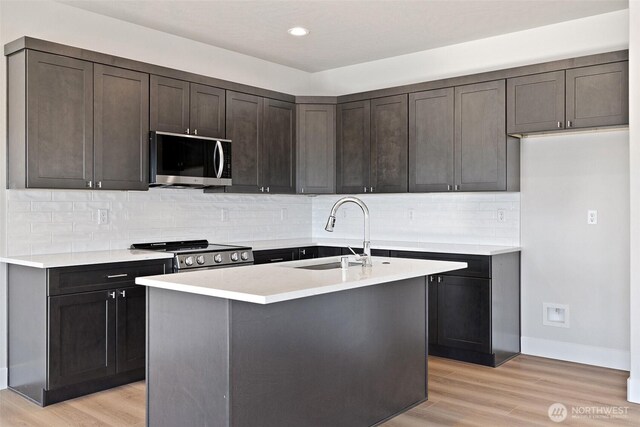 4247 W Sandy Ct, Moses Lake, WA 98837 - kitchen with stainless steel microwave, stove, a sink, light wood-style floors, and recessed lighting