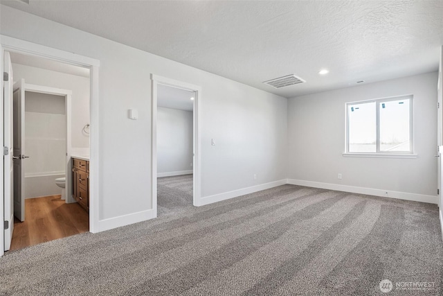 4247 W Sandy Ct, Moses Lake, WA 98837 - unfurnished bedroom with carpet floors, baseboards, a spacious closet, recessed lighting, and a textured ceiling