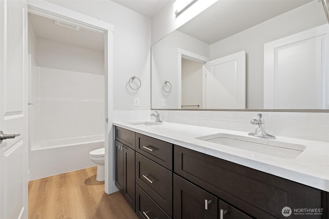 4247 W Sandy Ct, Moses Lake, WA 98837 - full bathroom with toilet, wood finished floors, and double vanity