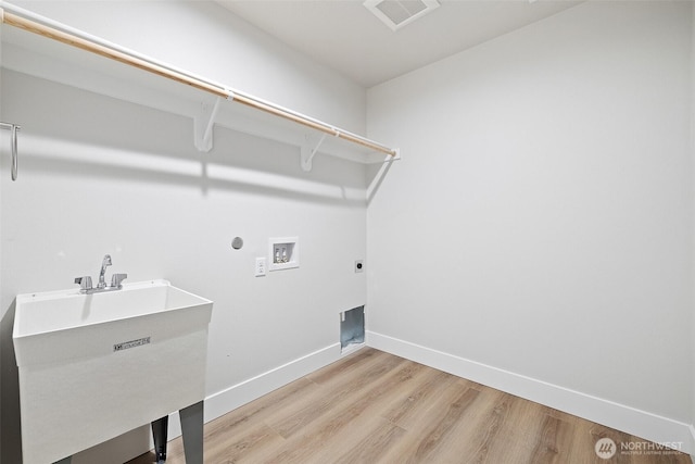 4247 W Sandy Ct, Moses Lake, WA 98837 - laundry room featuring washer hookup, light wood-style floors, electric dryer hookup, and baseboards