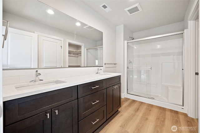 4247 W Sandy Ct, Moses Lake, WA 98837 - full bath with wood finished floors, a shower stall, double vanity, and recessed lighting