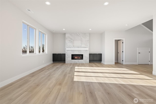 4235 W Sandy Ct, Moses Lake, WA 98837 - unfurnished living room with baseboards, recessed lighting, light wood-style floors, and a tile fireplace
