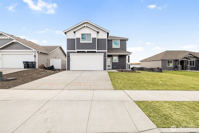 4235 W Sandy Ct, Moses Lake, WA 98837 - view of front of home featuring board and batten siding, concrete driveway, and a front lawn