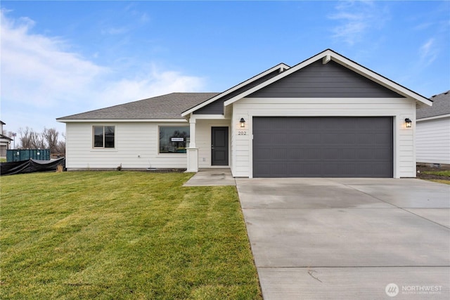 202 N Sandy Loop, Moses Lake, WA 98837 - ranch-style house with driveway, an attached garage, a front lawn, and roof with shingles
