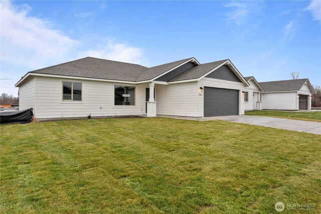 202 N Sandy Loop, Moses Lake, WA 98837 - ranch-style house with an attached garage, concrete driveway, a front lawn, and a shingled roof