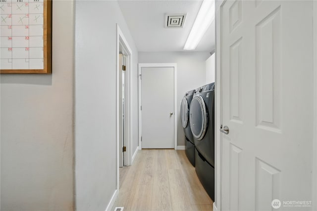 1210 Southview Dr, Walla Walla, WA 99362 - washroom with washing machine and clothes dryer, light wood-style flooring, and baseboards