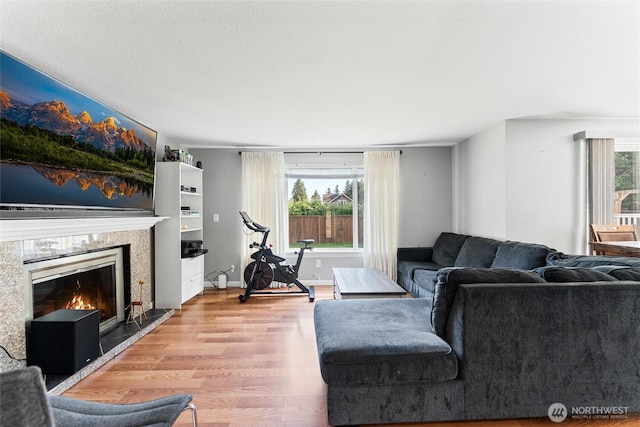 10319 SE 228th St, Kent, WA 98031 - living room featuring wood finished floors and a tile fireplace