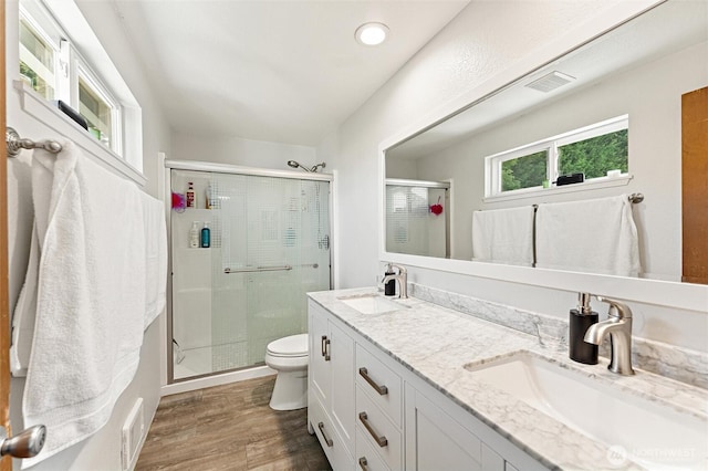 10319 SE 228th St, Kent, WA 98031 - bathroom featuring a shower stall, toilet, double vanity, and wood finished floors