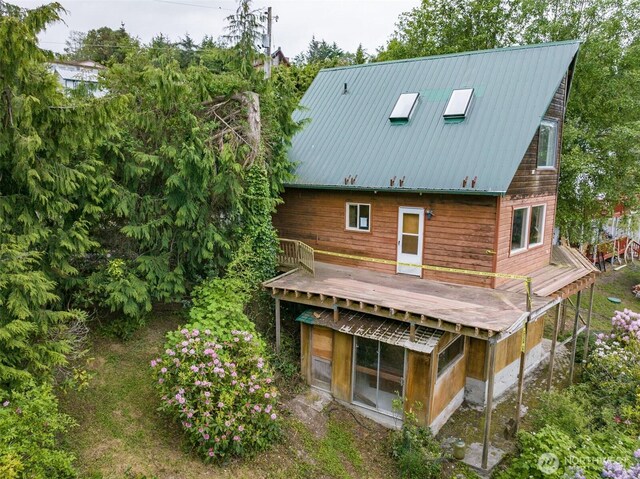 300 N St, Sequim, WA 98382 - rear view of property featuring a wooden deck and metal roof