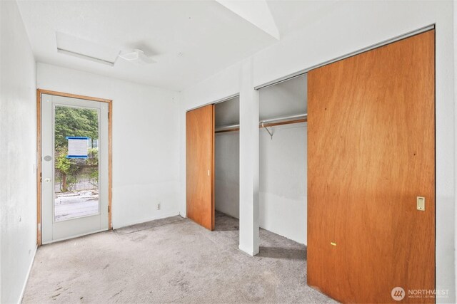 300 N St, Sequim, WA 98382 - unfurnished bedroom with carpet, two closets, access to exterior, and attic access
